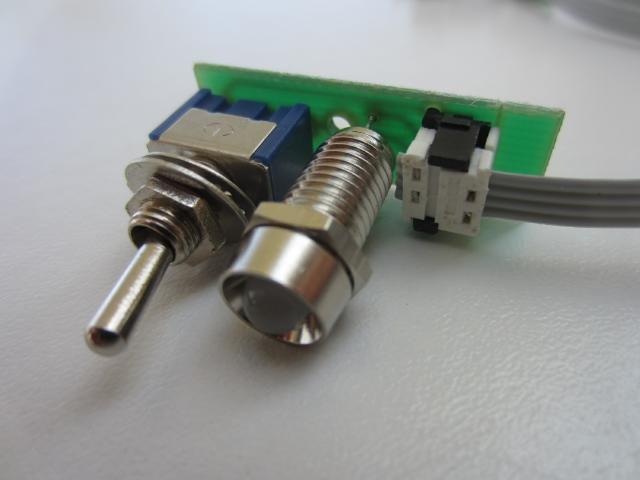 The kit consists of PCB, latching toggle switch, dual color (red/green) LED with chromed bezel and a convenient crimp connector