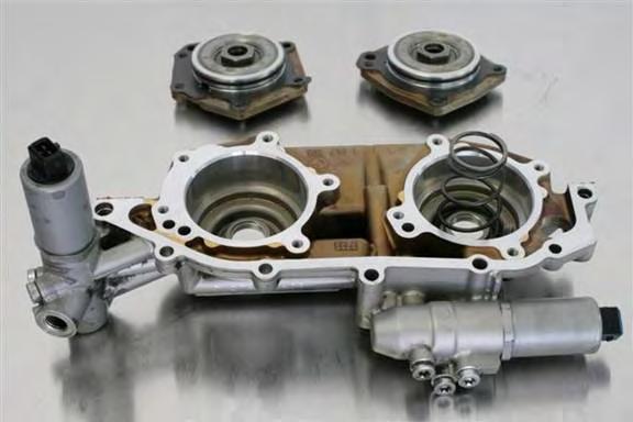 Install pistons fully into vanos cover cylinders. Install intake/exhaust pistons (previously marked) into associated covers. Intake side cover has 5 bolt holes and exhaust side cover has 4 bolt holes.