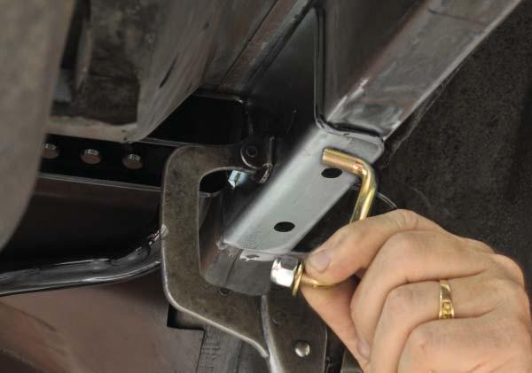 Through the access hole in the truck, slide the 1/4 -thick washer over the bolt and secure with a locknut. Tighten to 70 lb-ft. 33.