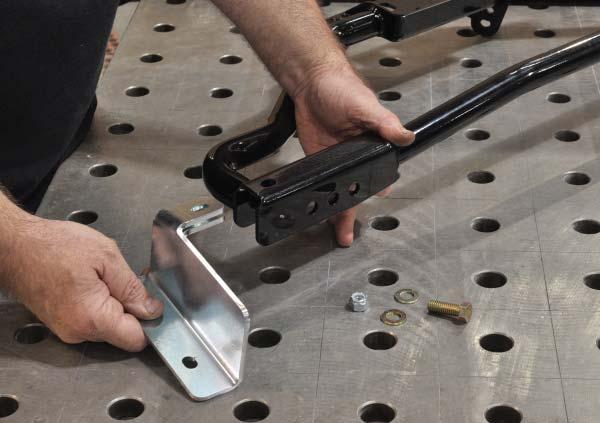 12. Prepare the frame rail brackets for welding to chassis by removing the zinc coating along the outside edges, where the welds will be made.