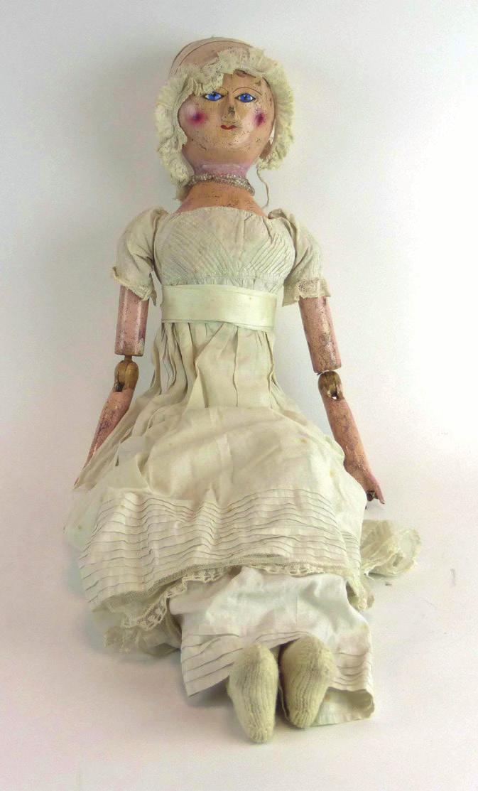 701 A late 18th century fully jointed carved wooden doll, the head with fi xed blue glass eyes and painted