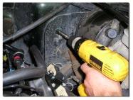 Use the correct drill bit and open the stock hole on the Jeep firewall. The hole must be big enough to accept the housing, but not too large for it to slip through.