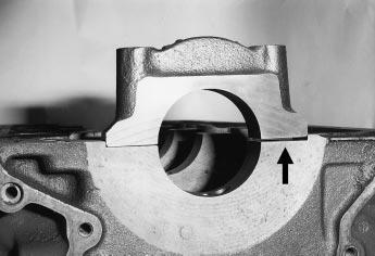 BUYING A USED STOCK ENGINE Main bearing cap being tapped into register by a copper hammer. Main bearing cap sitting on the edge of the block register.