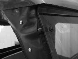 Check how the door panel fits under the front windshield. Adjust as needed. Tuck panel edge under windshield. Tuck panel edge under canopy.
