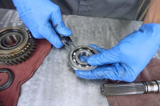 Tech Tip 9 Unlike the old main shaft rear bearing, the new bearing may have a snap ring groove with a snap ring in it.