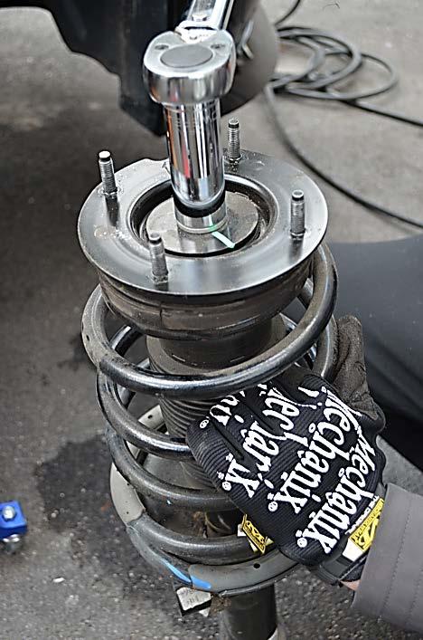 You may need to raise and lower the jack to line up the strut and hub in order to get the bolts out.