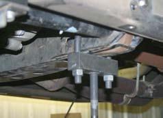 Slide the torsion bars into the lower control arms & push forward.