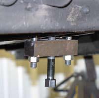 Remove both front OEM skid plates located in front of & under the front differential using a 15mm socket.