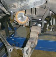 (See Arrow # 1 Photo # 19) Attach to the rear differential mount using the 9/16" x 4" fine thread bolts, washers, & nuts.