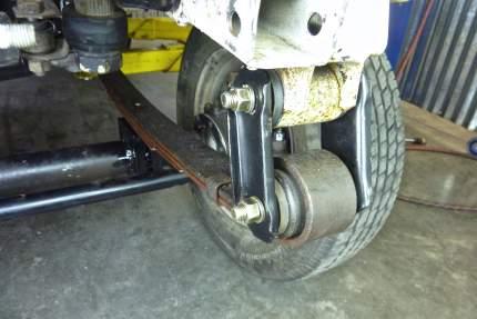 While lowering, insure that the passenger side leaf spring