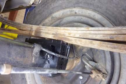 lift the leaf springs over the spring pads and roll the rear axle
