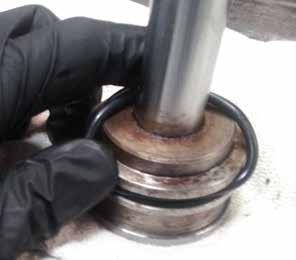 Carefully remove all dirt and debris from the piston and shaft.