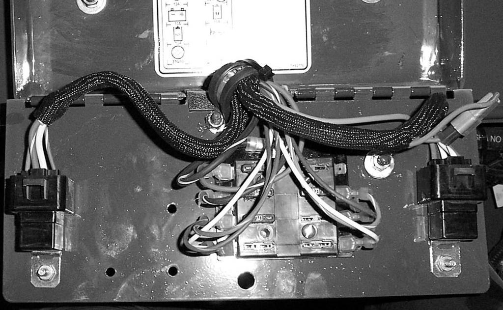 C3588) To access the electrical panel: 1 Open the rear door and raise the engine cover. 2 Remove the bolt holding the electrical panel cover closed. (fig.
