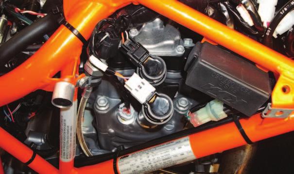 H 14 On the right side of the engine, locate and unplug the stock BLACK 2-pin connector from the inner coil stick and the stock
