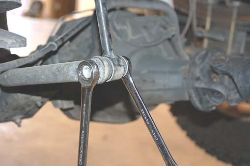 See Photo 5. Remove the 4 bolts that secure the front bumper to the frame using a 18mm socket. See Photo 6.