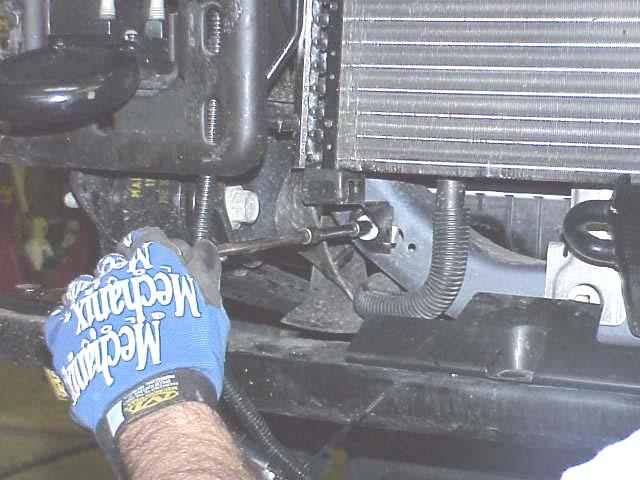 8. The radiator cooler lower mounts will have to be removed to allow the cooler to move outward to gain access to the front spring bolts.