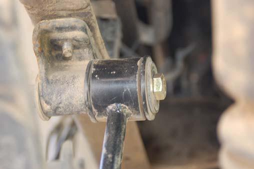 18. Remove the factory sway bar link bracket from the top of the frame using a 15mm wrench and reposition it under the frame. Tighten sway bar bracket hardware. 19.