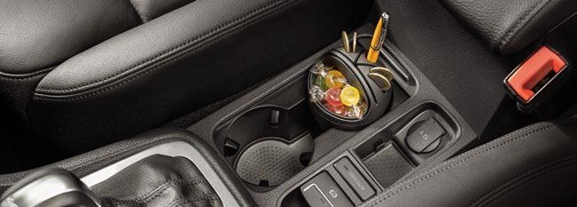 Interior. Cup holder. This multifunctional storage device is innovatively shaped, to fit a lot into a small space.