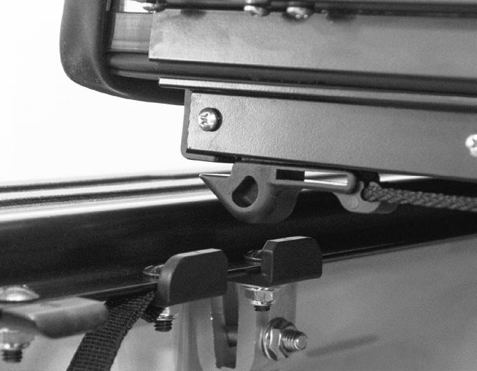 With cover hooks engaged underneath front catches, lower cover to engage latches in retainment brackets on each side.