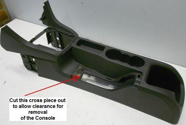 Remove the hand brake surround by levering up the base trim and pulling the trim and gaiter over the hand brake lever.
