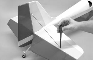 32) Using slow curing epoxy, apply a liberal amount to the bottom of the fin, insides of the rudder fairings, the fillet area on top of the fuselage, and into the bottom hinge hole in the fuselage.