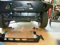 Lift the front bumper (A) onto the 6 forward facing bolts, it helps to have another