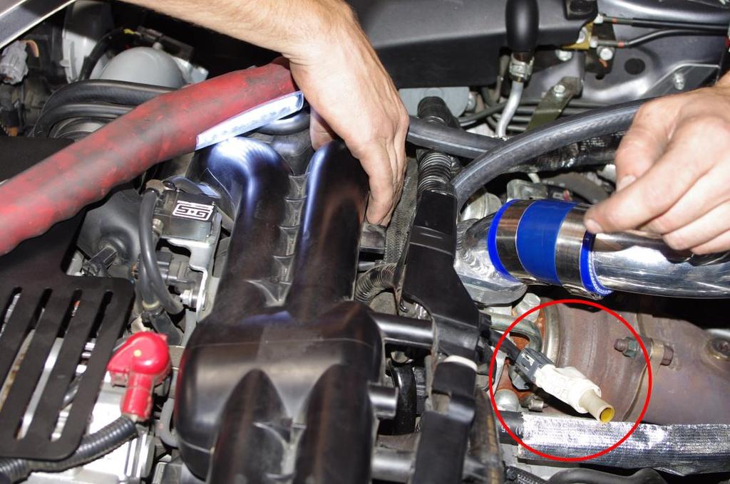 5. Remove the white breather piece from the hose running to the passenger side of the intake, and plug it