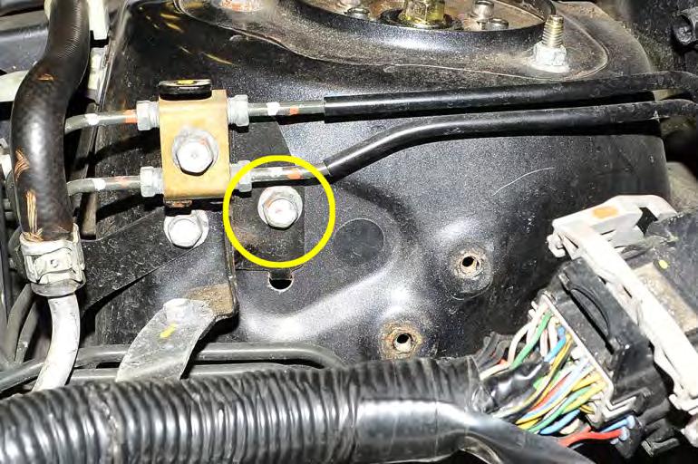 Remove the (1) 12mm bolt holding the brake line bracket to