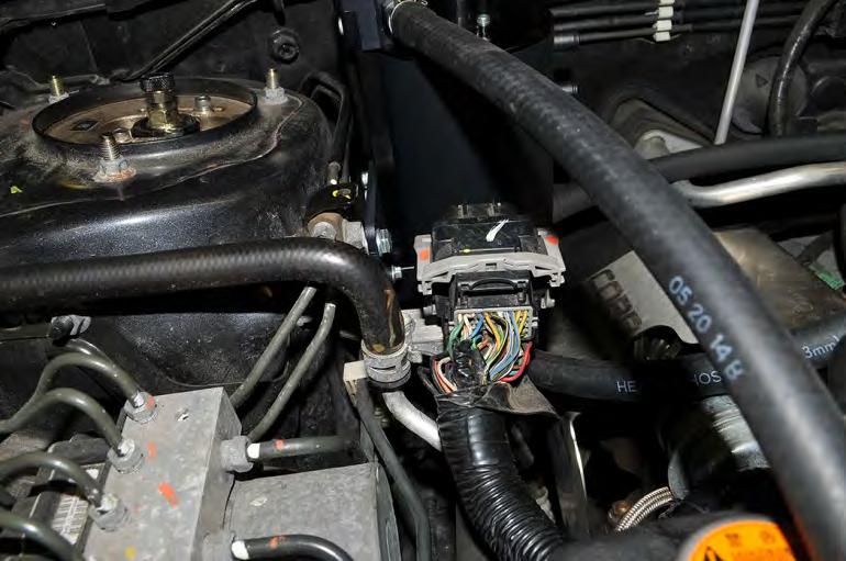 25. To minimize coolant loss, pinch off the lower coolant hose that connects the turbo to