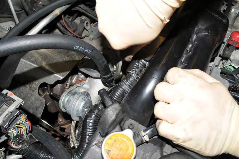 29. Install the upper AOS coolant hose onto the turbocharger hardline and secure the