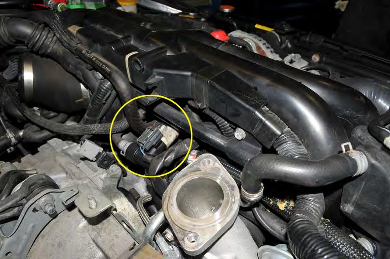 8. Next unplug the crankcase blow-by sensor by pressing the gray clip in and pulling outwards.