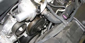 Remove coil covers from valve covers by lifting up and working fuel line through slot on driver side. 22.
