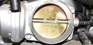 Use a 10mm socket to remove the four bolts holding in the throttle body and set it aside. 18.