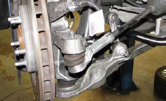 Use GM Ball Joint Separator #J 42188 to separate the steering knuckle from the tie
