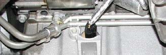 76. Work the power steering rack out through the driver side wheel well.