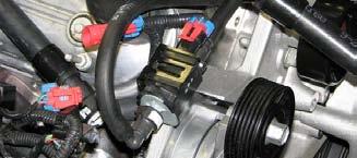 Use the supplied bit to drill a 15/64 hole in the passenger side of the upper radiator shroud according to