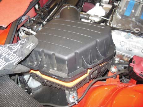 Release the locking clips on the air box cover and remove the air box lid from