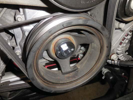 68. Replace the removed crank pulley mounting bolt with the provided drill guide and