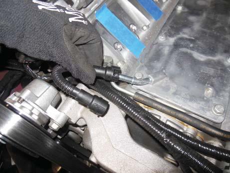 Earlier you removed one end of a short looping tube from the intake manifold on the right hand side