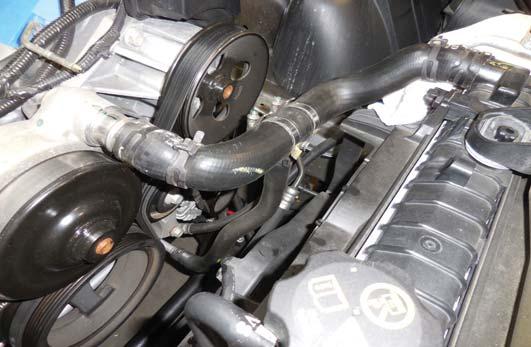 remove the mounting clamp and pull the upper radiator hose from the water