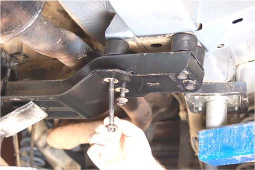 Support the transmission cross member using a floor jack and remove the 4 bolts on each side using a 15mm socket. See Photo 17. 32.