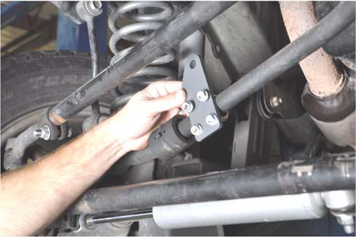 35. Install the new stabilizer bracket on the front side of the track bar with the