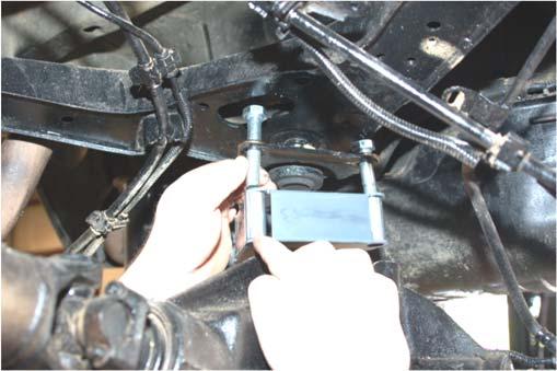 Using a 21mm socket remove the 3 bolts that secure the upper arm to the differential. See Photo 2.