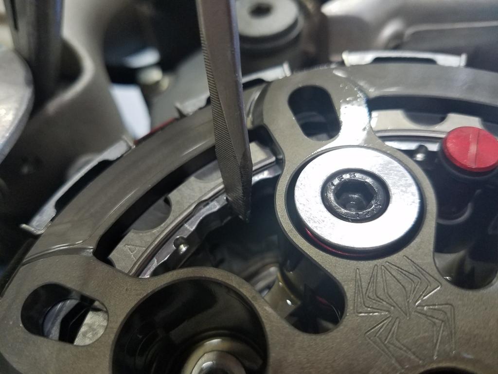 6. Using the adjustment notches, use a screwdriver or your fingers to turn the adjustment ring counterclockwise until it comes to a stop under the pressure plate.