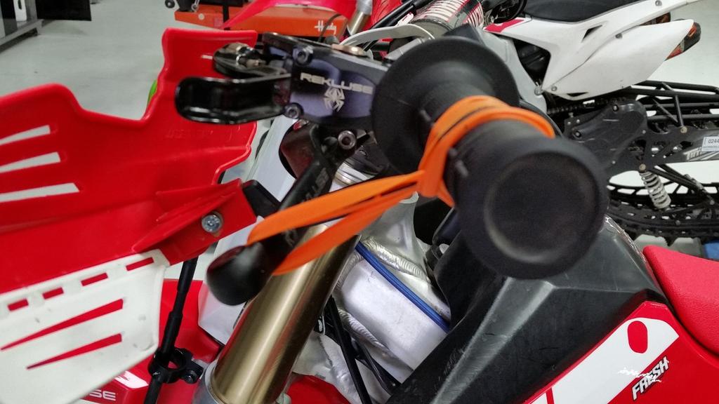 d) Pull the band through the loop, then attach it to the outside end of the clutch lever.