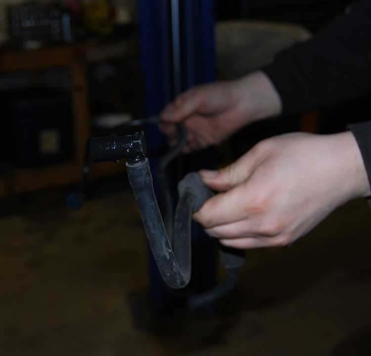 37. Pry down the plastic retainers that support the fuel and brake lines from the underside of the floor boards.