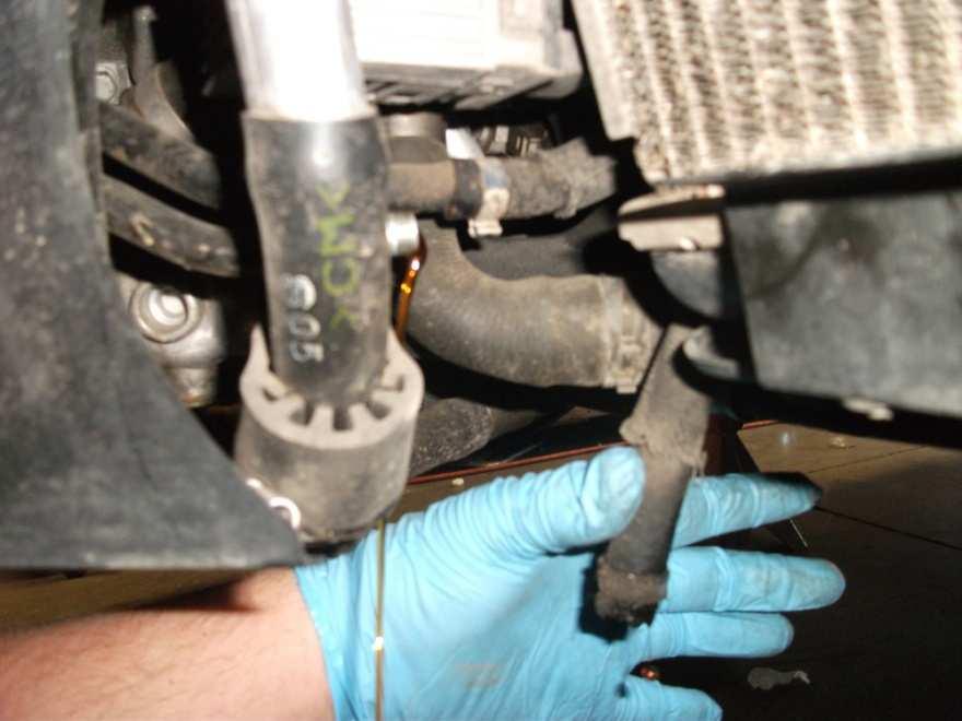 12. Disconnect the Two power steering cooler lines located on the lower driver s side of