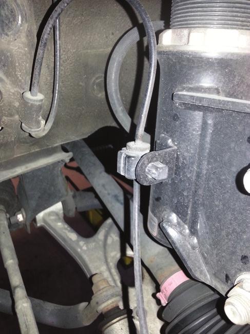 Remove bolt holding brake line to tab.