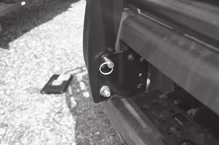Insert two frame spacers underneath the bumper on each side. Align the spacers with the holes shown below.
