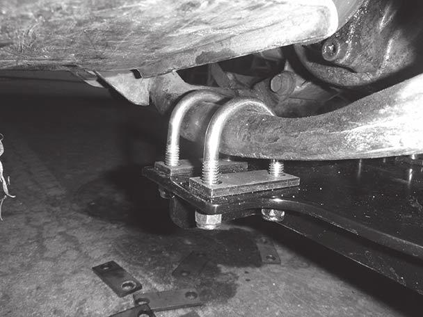 4. Place U-bolt shim plates in position on the top side of the skid pan assembly. Position two U-bolts on each side of the mount (four total), as shown.